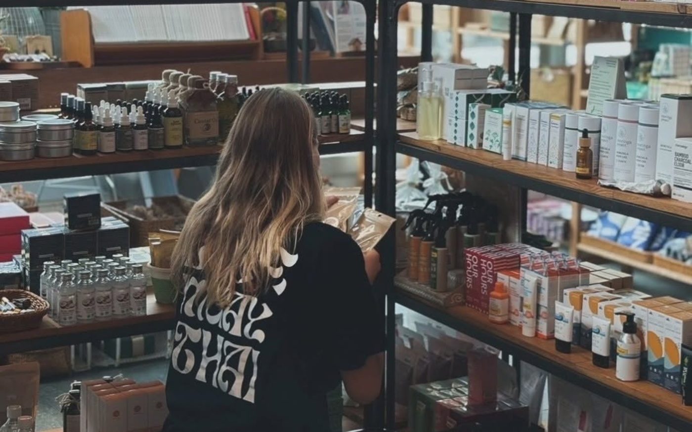 A customer browsing the shelves at Samui Health Shop in Lamai